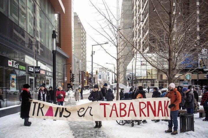 Photo of a trans rights protest. A banner saying 